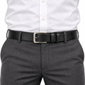 The Modern Belt in black leather with a silver buckle styled with a white shirt and gray trousers for a polished professional look