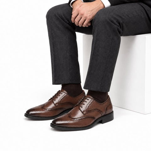 Prestige brown leather men's dress shoes with lace-up styling and brogue detailing shown on a seated man for a polished professional look and discreet height boost