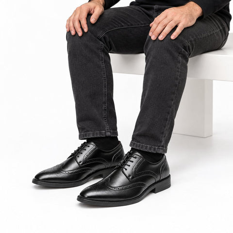 Prestige black mens dress shoes with polished leather finish and brogue detailing offering a discreet height boost for a refined professional look
