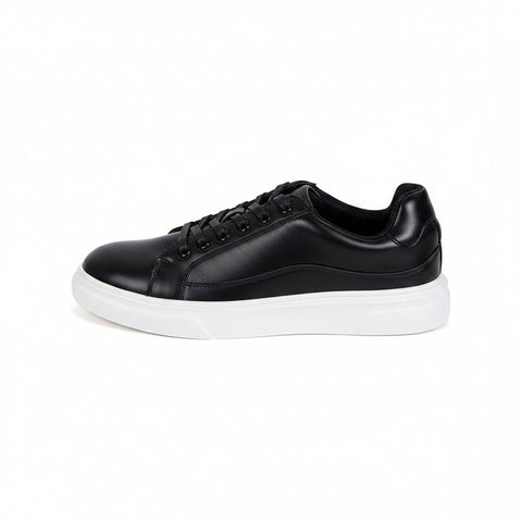 Radcliffe black leather sneaker with a white sole, featuring a discreet height boost, modern style, and comfortable insoles.