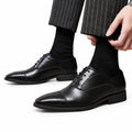 Regal black leather mens dress shoes with sleek cap toe styling and a discreet height boost for polished formal occasions