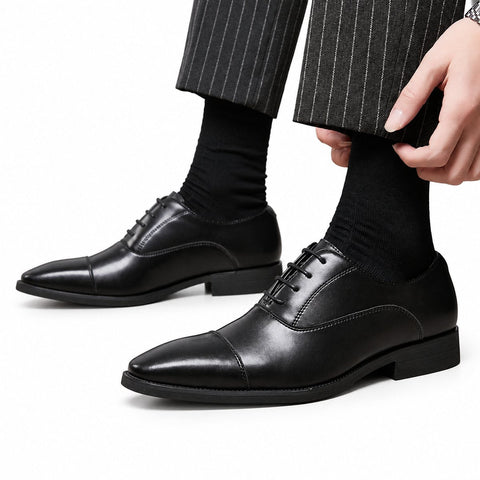 Regal black leather mens dress shoes with sleek cap toe styling and a discreet height boost for polished formal occasions