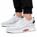 Rise33 white mesh sneakers with cushioned soles and discreet height boost shown on feet for modern athletic style and everyday comfort
