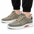 Rise33 beige knit men's sneakers with beige laces, cushioned white soles, red accents and a discreet height boost shown on foot