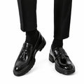 Sterling black polished leather tassel loafers with a discreet height boost and sturdy soles for sophisticated men's dresswear