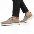 Strider camel men's casual shoes with textured knit uppers, white soles and a discreet height boost shown on a model