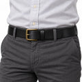 The Classic Belt black belt with gold tone buckle styled with gray trousers and a white button down shirt for a polished mens outfit