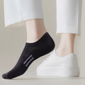 A black low-cut sock worn with a white casual sneaker.