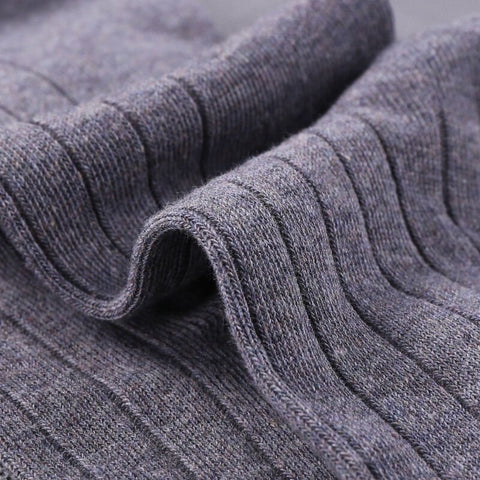 Close-up of ribbed gray sock fabric, showing the texture.