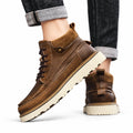 Timberline brown lace-up boots worn with cuffed jeans for a discreet height boost