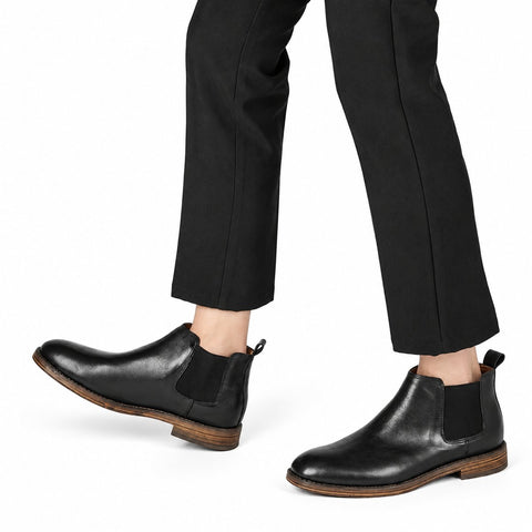 Wellington black leather Chelsea boots with elastic side panels and a discreet height boost worn with black trousers